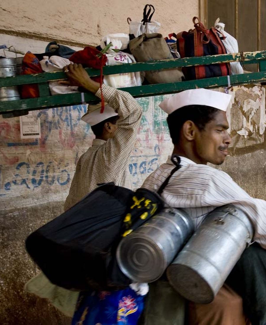 Traditional tiffin boxes being carried for delivery, home-style meal service